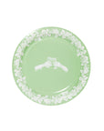 Green plate with white floral pattern on a white background